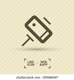 a self mobile phone in a holder self isolated minimal single flat linear icon in color. Line vector icon for websites and mobile minimalistic flat design.