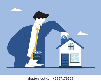 Self-build house construction loan. Mortgage for building concept. Man holding a stack of coins putting one coin into house roof building. Construction costs covered by bank. Investment in building.
