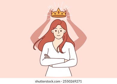 Self-confident woman with crown above head stands with arms crossed in front of chest and looks at screen smiling. Self-confident girl rejoices at gold award for achieving success in career