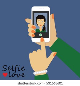 Selfie love. Woman with polished nails shooting selfie photo with her mobile phone.