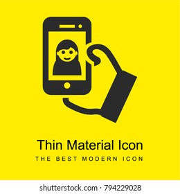Selfie on phone screen on a hand bright yellow material minimal icon or logo design