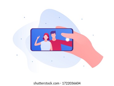 Selfie photo concept. Vector flat person illustration. Hand holding smartphone. Couple of male and female on device screen. Friendship and romatic date. Design for banner, poster, web.