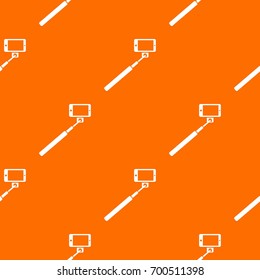 Selfie stick and smartphone pattern repeat seamless in orange color for any design. Vector geometric illustration