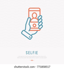 Selfie thin line icon. Hand holding smartphone with silhouette. Modern vector illustration.