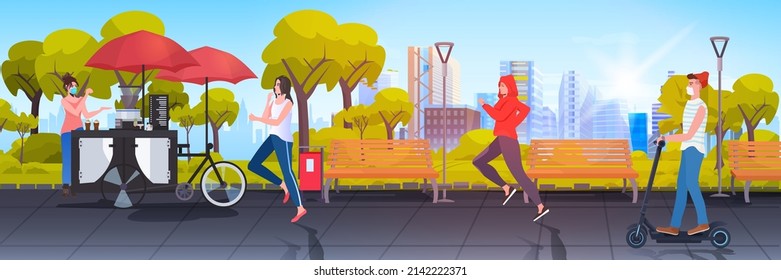 seller in mask standing near small street food market with cupcakes and coffee people relaxing in urban park