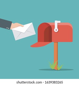 Send mail concept.Paper envelope with letter sending in red mailbox.