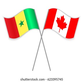 Senegalese and Canadian crossed flags. Senegal combined with Canada isolated on white. Language learning, international business or travel concept.