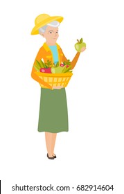 Senior caucasian farmer holding basket with fresh harvest of vegetables and fruits. Farmer harvesting harvest of vegetables and fruits. Vector flat design illustration isolated on white background.