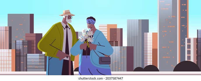 senior couple with flowers having a date african american grandparents spending time together cityscape background