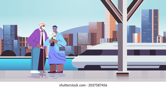 senior couple with flowers having a date on railway station african american grandparents spending time together