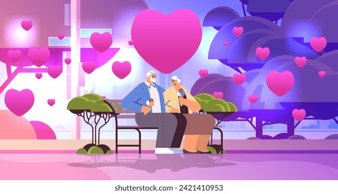 senior couple in love sitting on bench and eating ice cream grandparents with pink hearts spending time together in park valentines day