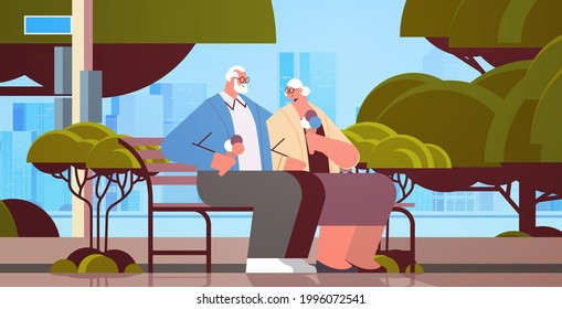 senior couple sitting on bench and eating ice cream happy grandparents spending time together in park