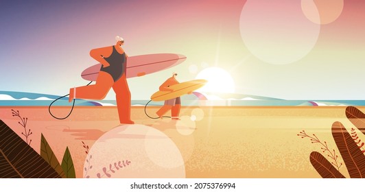 senior couple with surf boards aged man woman surfers holding surfboards summer vacation active old age concept