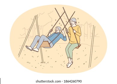 Senior elderly couple living happy active lifestyle concept. Happy mature loving couple pensioners woman and man riding on swing and having fun like children outdoors. Retiree, pensioner happiness