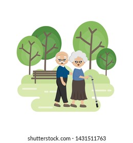 Senior Elderly couple in the park. Old man helping  an old woman with walking stick.
