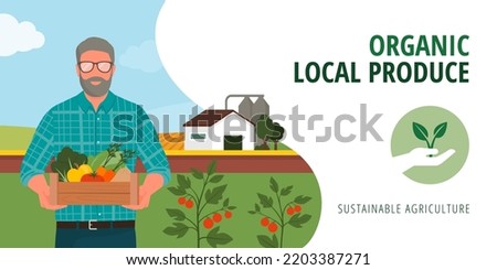 Senior farmer holding a crate with fresh organic vegetables and fruits, farm in the background: sustainable organic agriculture and local produce concept, banner with copy space