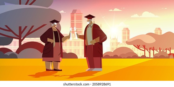 senior graduated students in graduation caps walking in park aged graduates celebrating academic diploma degree