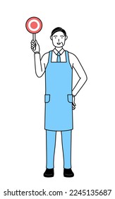 A senior man in an apron with his hands folded in front of his body.