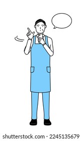 A senior man in an apron operating a smartphone.