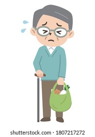 Senior man carrying heavy luggage