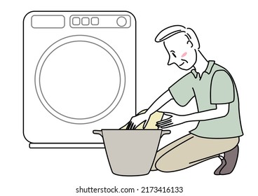 Senior man doing laundry. Happy mature man washing clothes. Homemaker doing laundry at home. Elderly man loading clothes into the washer. Mature man putting laundry in basket in front of washer.