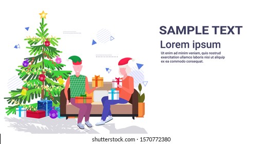senior man in elf hat giving present gift box to mature woman family sitting on couch celebrating merry christmas happy new year winter holidays concept full length copy space horizontal vector