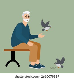 Senior man feeding birds in the park