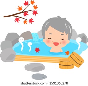 Senior man in the outdoor hot spring with autumn leaves