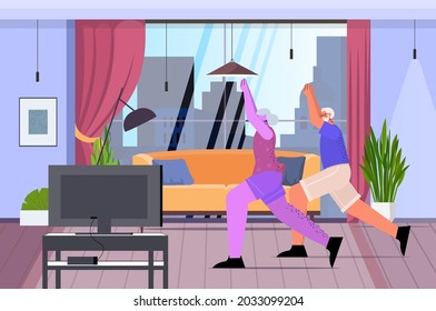 senior man woman couple doing fitness exercises watching tutorials on tv online training healthy lifestyle active old age