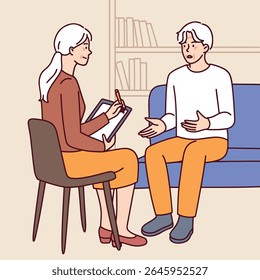 Senior man and woman sit indoors and talk calmly, sharing thoughts and opinions in peaceful conversation and relaxed home environment