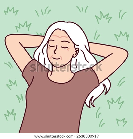 Senior old older elder Joyful white-haired woman. Senior woman with white hair lies on grass with closed eyes and hands behind head. Symbol of peaceful retirement, self-care, and emotional well-being