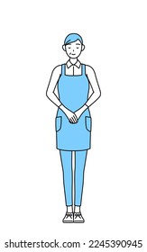 A senior woman in an apron bowing with folded hands.