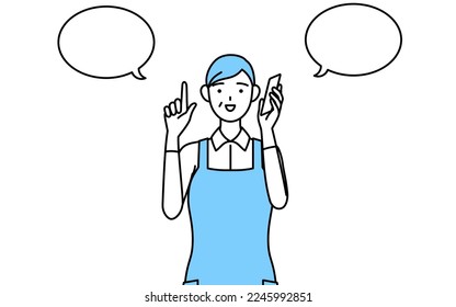 A senior woman in an apron pointing while on the phone.