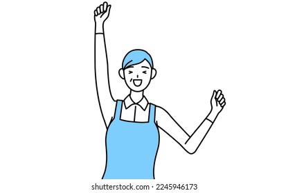 A senior woman in an apron smiling and jumping.