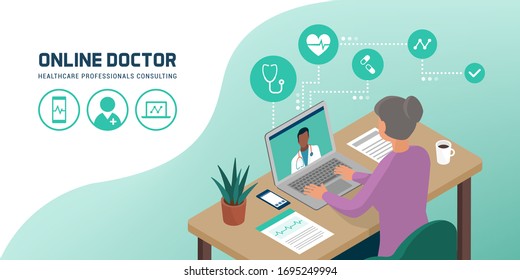 Senior woman connecting with her laptop and videocalling her doctor from home, telemedicine concept