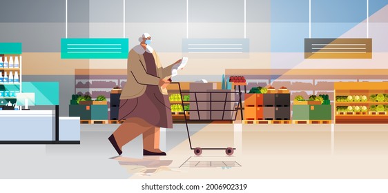 senior woman with full of products trolley cart checking shopping list in supermarket