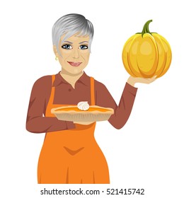 senior woman holding freshly baked homemade pumpkin pie