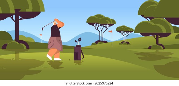 senior woman playing golf on green golf course aged player taking a shot active old age concept