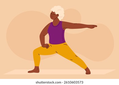 Senior woman practicing yoga in warrior pose. Confident elderly person doing fitness exercise on mat. Concept of healthy aging, strength, flexibility, active lifestyle and wellness.