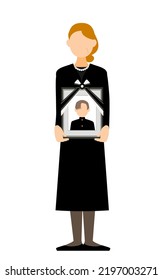 Senior woman standing with her son's portrait