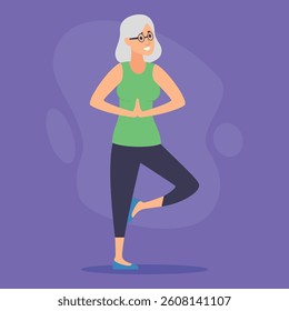Senior woman standing in yoga pose, balancing on one leg with hands together. Girl smiling and wearing top and yoga pants in cozy home environment. Wellness and fitness concept