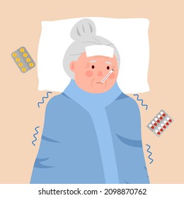 Senior woman suffering from flu with blanket. Old female has fever and take thermometer in mouth. Cold or influenza disease concept. Season allergy.
