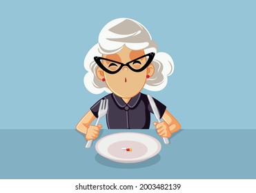 Senior Woman Taking Medical Treatment Before Eating. Elderly granny looking at her pills sitting in the plate getting her medication before or after her meal
