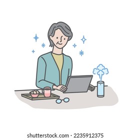 Senior woman using a tablet while using a desktop humidifier to prevent dryness