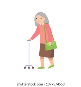 Senior woman walking with metal stick and green handbag