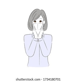 Senior woman wearing a mask and putting her hands on her cheeks