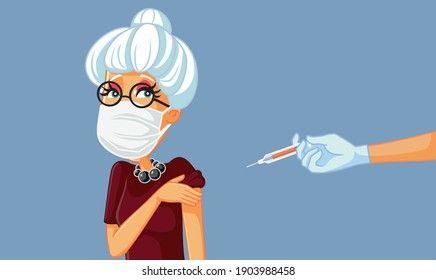 Senior Woman Wearing Medical Mask Getting a Vaccine. Elderly adult person obtaining anti viral immunization trough vaccination 
