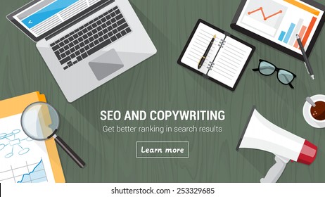 Seo and copywriting concept desk with computer, tablet, megaphone and magnifier