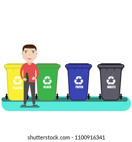 separate waste collection. man is standing near garbage cans with bottle in hand. 