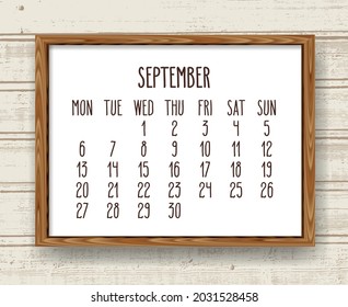 September year 2021 vector monthly calendar. Week starting from Monday. Hand drawn text in a wooden frame over rustic distressed light wood background.